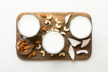Set or collection of various vegan milk almond, coconut, cashew, on table background. Vegan plant...