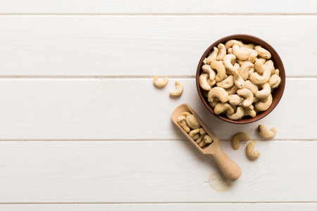 cashew nuts in wooden bowl on table background. top view. Space for text. healthy foodの写真素材