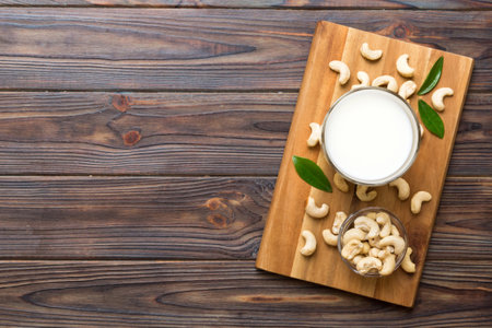 Vegan milk from cashews in bottles on wooden table, Vegetarian alternative food, clean eating concept. top view with copyspace.の写真素材
