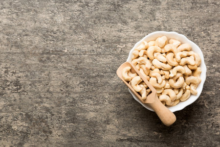 cashew nuts in wooden bowl on table background. top view. Space for text. healthy foodの写真素材