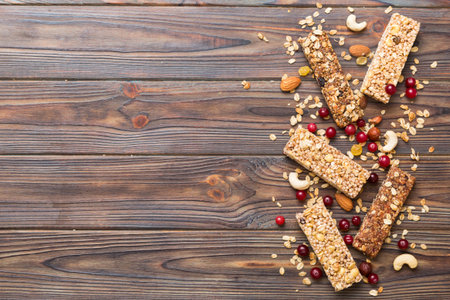 Various granola bars on table background. Cereal granola bars. Superfood breakfast bars with oats, nuts and berries, close up. superfood concept.の写真素材