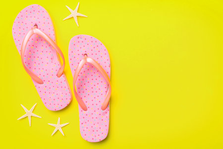 Flat lay composition with flip flops and seashell on colored background. Space for text view.の写真素材