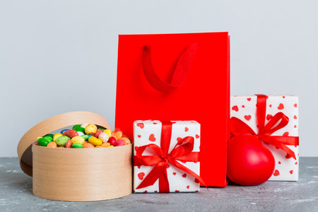 Shopping bag with gift box on colored background perspecrive view. Space for text holiday concept.の写真素材