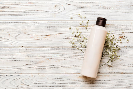 Fancy healthcare bottles for cream with gypsophila branch. Natural oranic spa cosmetics concept. Mockup, template, top view.の写真素材