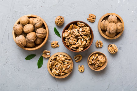 Walnut kernel halves, in a wooden bowl. Close-up, from above on colored background. Healthy eating Walnut concept. Super foods with copy space.の写真素材