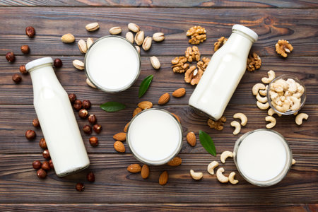 Set or collection of various vegan milk almond, cashew, on table background. Vegan plant based milk...