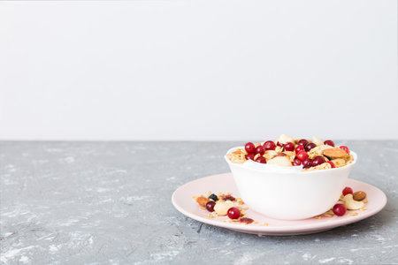 Healthy breakfast food with granola, yogurt, fruits and nuts. Dessert parfait with dried fruits for breakfast.の写真素材