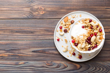 Healthy breakfast food with granola, yogurt, fruits and nuts. Dessert parfait with dried fruits for breakfast.の写真素材