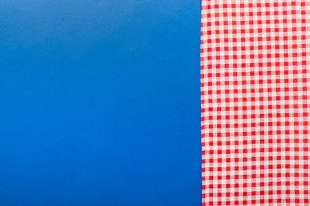 top view with red empty kitchen napkin isolated on table background. Folded cloth for mockup with...