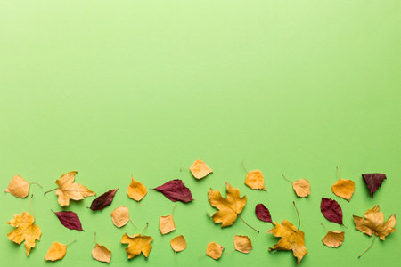 autumn composition. Pattern made of dried leaves and other design accessories on table. Flat lay,...