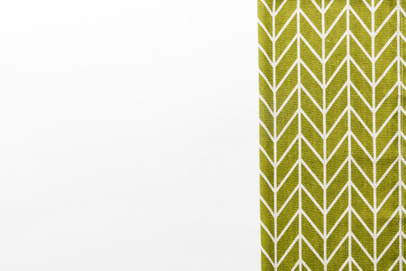 top view with green kitchen napkin isolated on table background. Folded cloth for mockup with copy space, Flat lay. minimal style.の写真素材