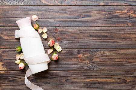 Fancy healthcare bottles for cream with rose flower. Natural oranic spa cosmetics concept. Mockup,...
