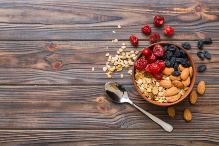 Cooking a wholesome breakfast. Granola with Various dried fruits and nuts in a bowl. The concept of...