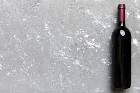 One Bottle of red wine on colored table. Flat lay, top view wth copy space.の写真素材