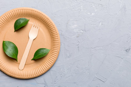 set of empty reusable disposable eco-friendly plates, cups, utensils on light white colored table background. top view. Biodegradable craft dishes. Recycling concept. close-up.の写真素材
