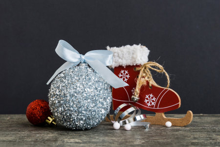 Christmas ball with skates on colored background. decoration bauble with ribbon bow with copy space.