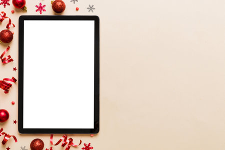 Christmas online shopping from home tablet pc with blank white display top view. Tablet with copy...