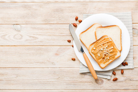 Peanut butter sandwiches or toasts on light table background.Breakfast. Vegetarian food. American...