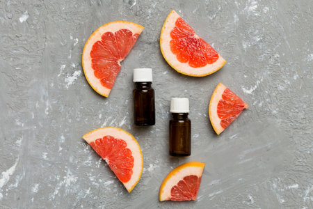 Bottles with Grapefruit fruit essential oil on wooden background. alternative medicine top view with copy space.の写真素材