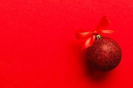Christmas ball on colored background. decoration bauble with ribbon bow with copy space.の写真素材
