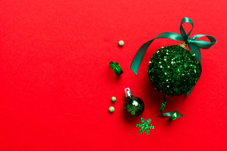 Christmas ball on colored background. decoration bauble with ribbon bow with copy space.の写真素材