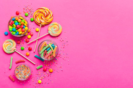 Tasty appetizing Party Accessories Happy Birthday Sweet. Different types of candies on colored background, copy space. Colorful birthday party background.の写真素材