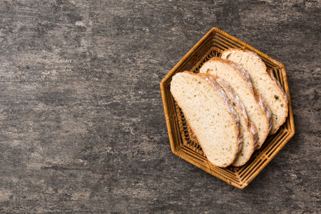 Freshly baked bread slices on basket against natural background. top view Sliced bread.の写真素材