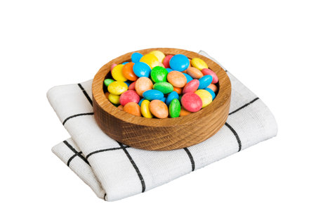 Multicolored candies in a bowl on a colored background. birthday and holiday concept. Top view with copy space.の写真素材