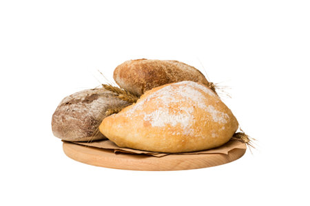 Freshly baked bread on cutting board isolated on white background. perspective view bread with copy...