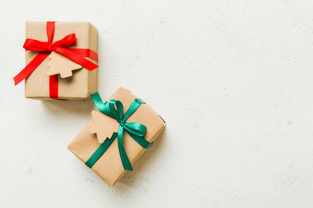 wrapped christmas or other holiday handmade present in paper with colored ribbon. Present box,...