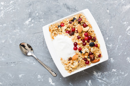 Healthy breakfast food with granola, yogurt, fruits and nuts. Dessert parfait with dried fruits for breakfast.の写真素材