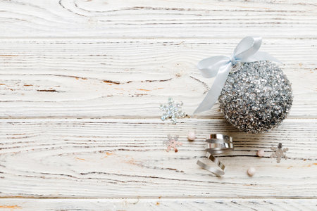 Christmas ball on colored background. decoration bauble with ribbon bow with copy space.の写真素材