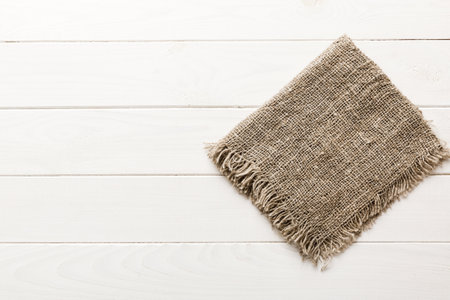Old burlap fabric napkin, sackcloth on table background. top view with copy space.の写真素材