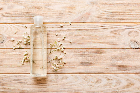 Fancy healthcare bottles for serum, micellar, tonic, toner, lotion, water and cream with gypsophila branch. Natural oranic spa cosmetics concept. Mockup, template, top view.の写真素材