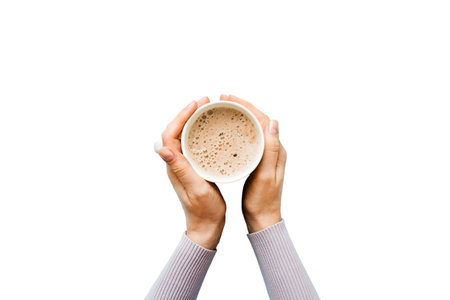 Minimalistic style woman hand holding a cup of coffee on Colored background. Flat lay, top view...