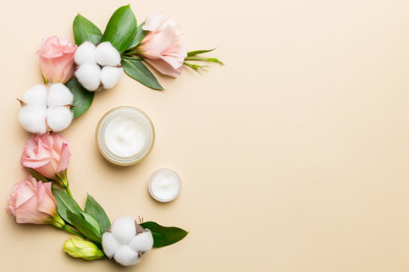Composition with cosmetic products and beautiful roses on wooden background. Copy space, flat lay.の写真素材
