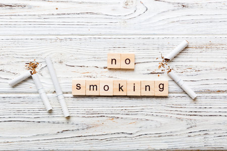 Cigarette And Wooden Blocks, Broken cigarette on table background, No Tobacco Day with hourglass, clock health concept. time to quit smoking.の写真素材
