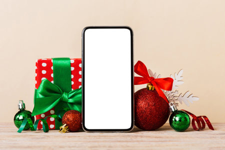 Digital phone mock up with rustic Christmas decorations for app presentation with empty space for you design. Christmas shopping concept. Tablet with copy space on colored background.の写真素材