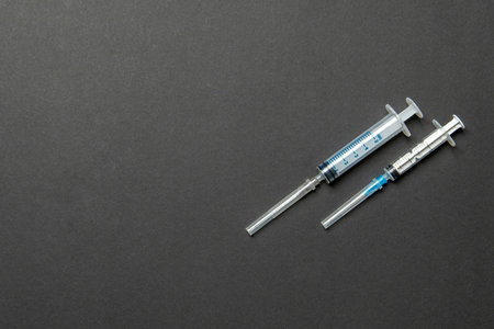 Top view of syringes in a row for medical injection on colorful background with copy space. Health and vaccination concept.の写真素材