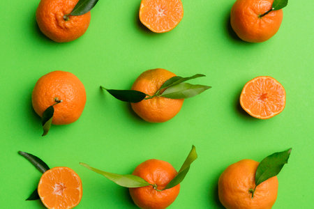 Many fresh ripe tangerines as colored background, top view. Elegant background of clementines and mandarin slices Top view flat lay.の写真素材