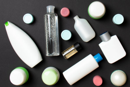 Close-up set of diffrent sized bottles and jars for cosmetic products on colored backgound. Face and body care concept with copy space.の写真素材