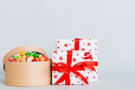 Valentine day composition: sweet candy, with gift boxes with bow and red felt hearts, photo template, background. Perspective with copy space.の写真素材