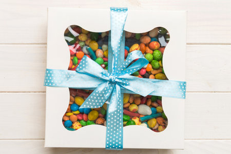 Box with sweet chocolate candies on color background, Various candy sweets. Valentines day gift box....