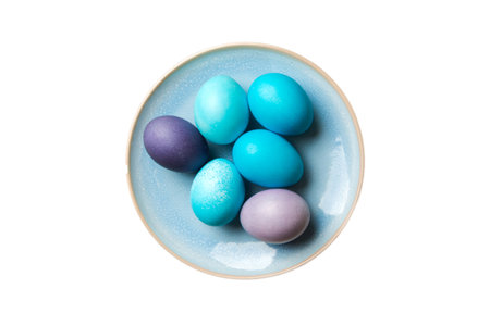 Basket of colorful Easter eggs isolated on white background. Easter basket filled with colored eggs top view holiday concept.の写真素材