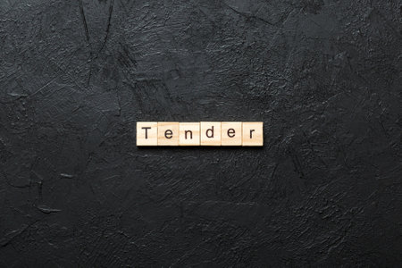 tender written word on wood block. tender text on table, concept.の写真素材