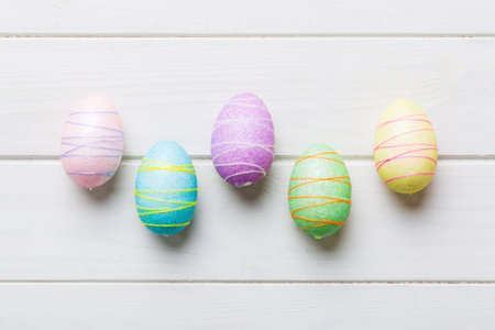 decorative easter eggs on colored background. easter eggs collection top view with copy space.