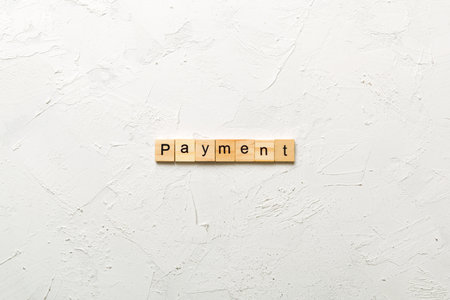 Payment written word on wood block. Payment text on cement table for your design, concept.の写真素材