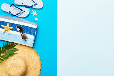 Top view travel or vacation concept. Composition with stylish beach accessories on colored...