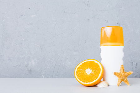 dispenser bottle and Citrus fruit in skincare product. beauty spa medical skincare and cosmetic lotion bottle cream product on table decor background with summer accessories.の写真素材