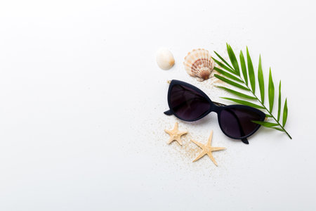 sunglasses with seashell lying on table background. Sunglasses on summer background. Top view flat...